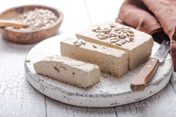 Sunflower halva with seeds  on wooden background. Festive Oriental delicacy stock photo