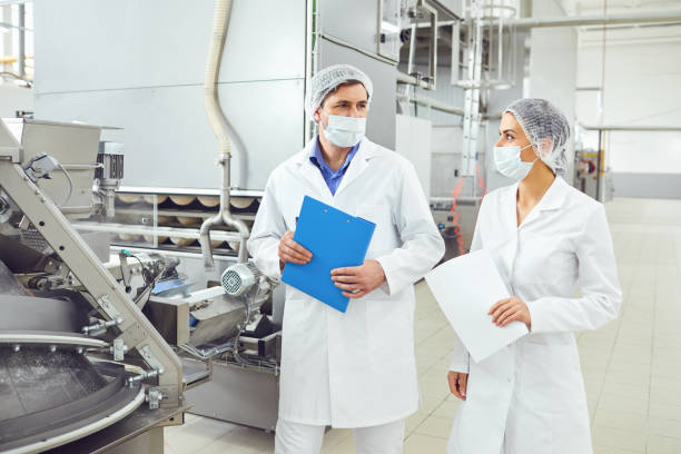 istock Technologists inspector in masks at food factory. 1192227564