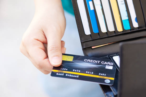 istock Left hand pulling or keeping credit card (mock up) from or into front jeans pocket in landscape layout style 1192230128