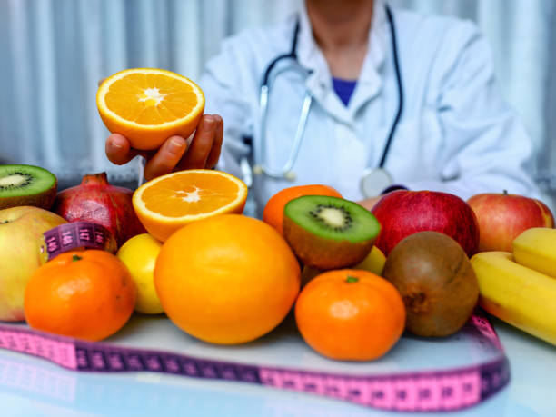 istock Doctor holding orange 1192231611