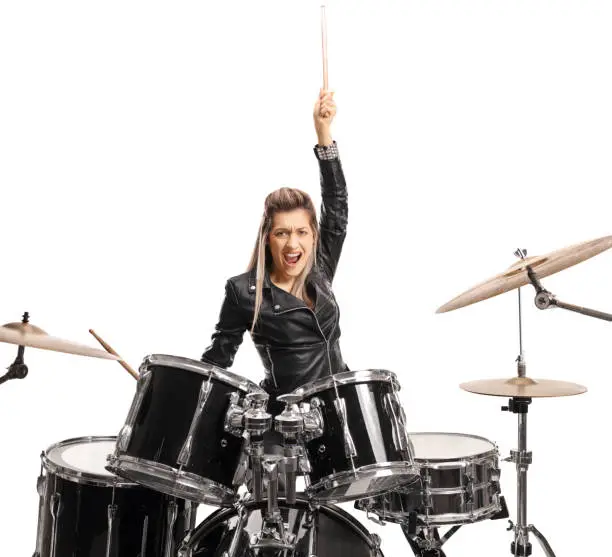Photo of Excited female drummer raising a drumstick