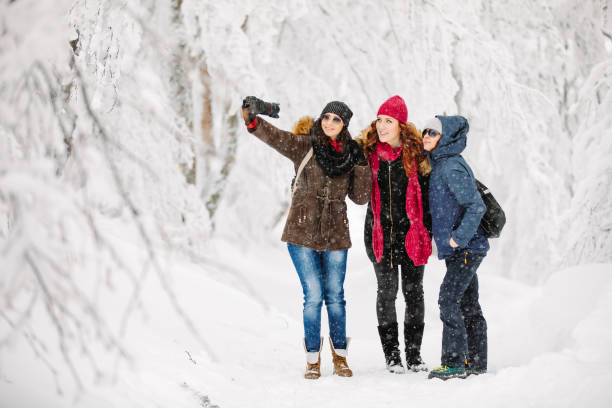 istock Friends taking selfie on snow 1192236510