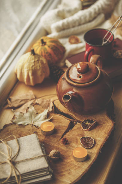 istock High angle view of tea pot with autumn decorative objects placed on the wooden board 1192238090