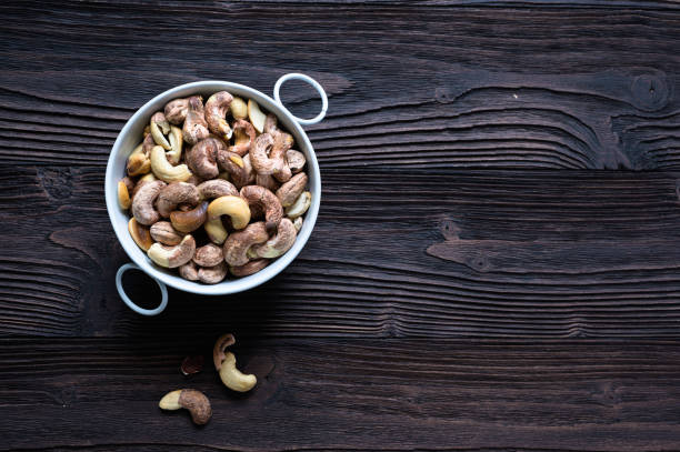 istock Roasted cashews on natural wooden table background 1192242249