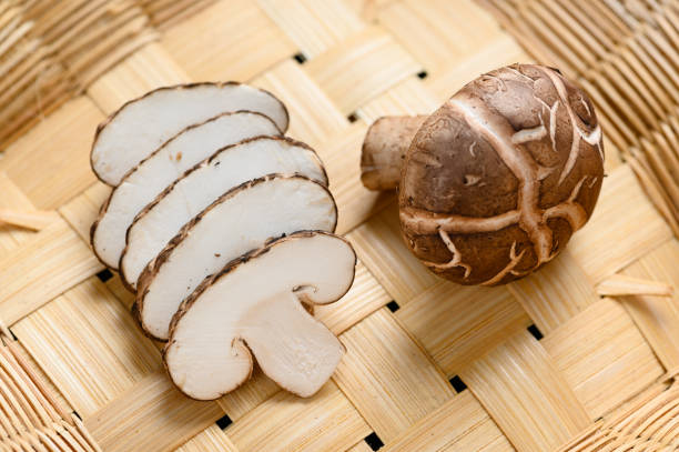 istock Shiitake mushrooms on the wooden background. 1192242422