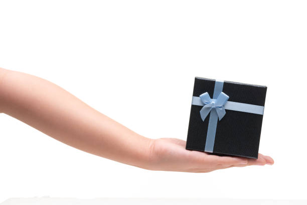 istock Girl Hand Hold Gift box with blue ribbon isoalted on white 1192242654