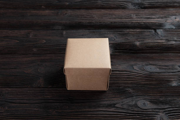 istock Cardboard box on a wooden background 1192242670