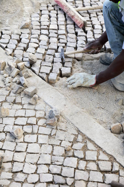 Cascais, Portugal - June 21, 2012:Construction worker is repairing a road in Cascais, Portugal