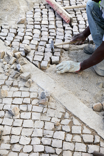 Cascais, Portugal - June 21, 2012:Construction worker is repairing a road in Cascais, Portugal
