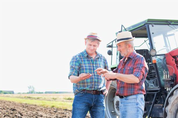 istock Farmers discussing over soil in farm 1192248779