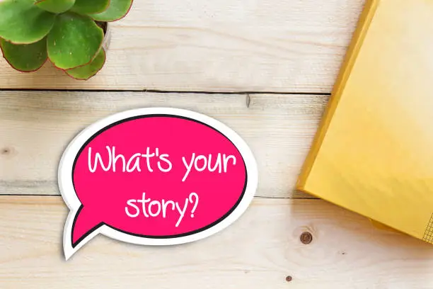 Photo of What Is Your Story Speech Bubble On wooden Background