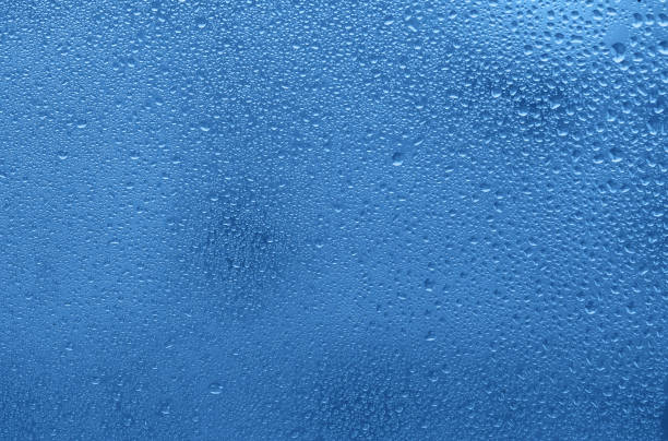 istock Window with water drops. Blue colored trendy background. 1192251140