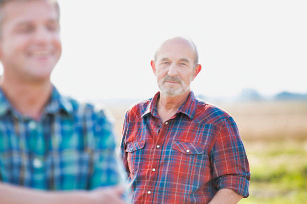 istock Farmers standing in field 1192252678