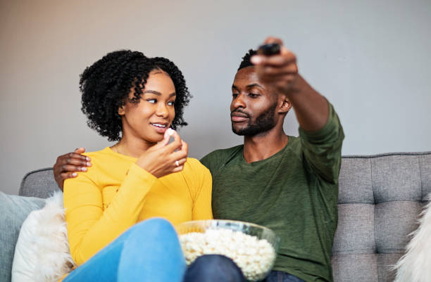 istock Couples Watching Tv Together Over Popcorn 1192252984