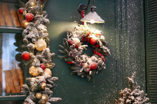 istock Christmas bakery window. Freshly baked bread sold in a bakery window. A bakery showcase and a nearby Christmas fir wreath with a red ribbon hanging. Facade of street cafe. Winter cafe decor. new Year 1192254556