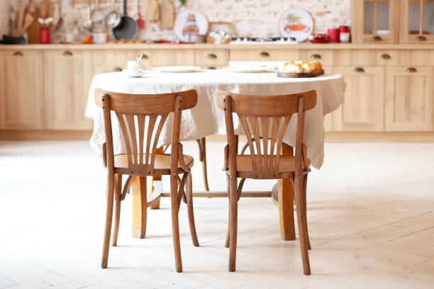 istock dining room in a cottage style. brown kitchen with a round rustic dining table with chairs. Outdoor dining room interior with kitchenette and brick walls for a warm, cozy atmosphere. Rustic kitchen 1192254809
