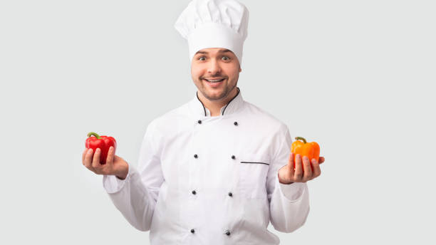 istock Smiling Chef Man Holding Sweet Peppers Over White Background, Panorama 1192255637