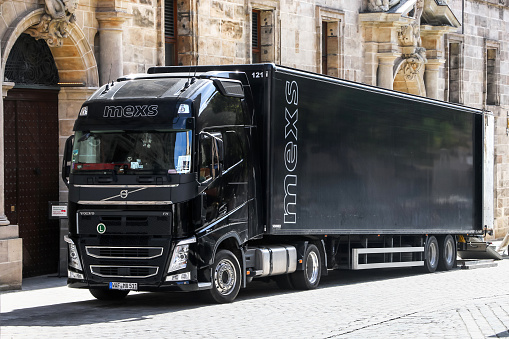 Nuremberg, Germany - September 19, 2019: Black semi-trailer truck Volvo FH12 in the city street.