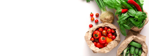 istock Garden fresh vegetables in eco friendly bags on white 1192255771