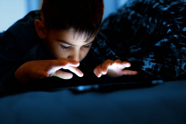 istock Boy watching movie on digital tablet 1192255964