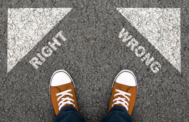 istock Man in sneakers choosing right or wrong way 1192256239