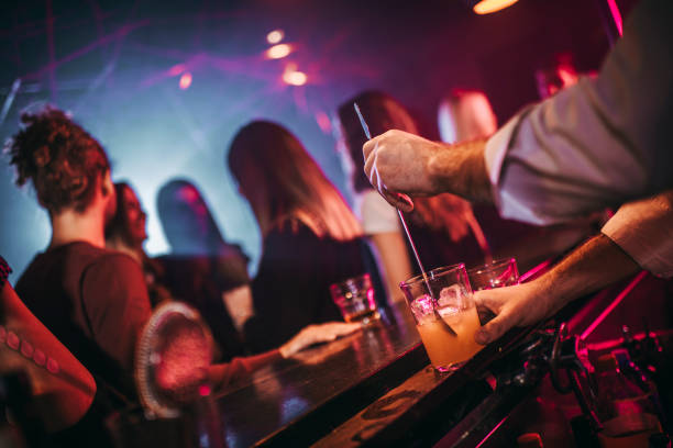 istock Barman serving a cocktail at a bar counter during a party 1192257217
