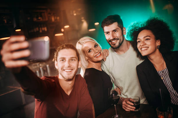 istock A diverse group of friends taking a group selfie with a smart phone while having a night out in the club 1192257455