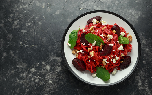 Roast Beetroot Pasta with spinach, walnuts and feta cheese. healthy food.