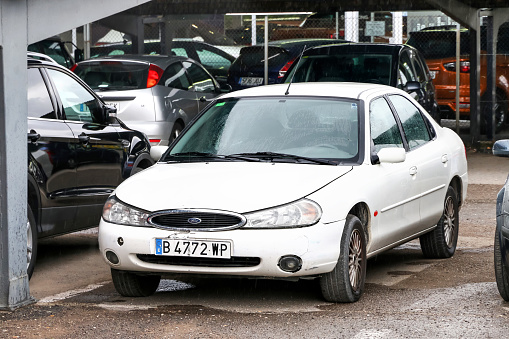 Igualada. Spain - September 10, 2019: Old saloon car Ford Mondeo in the city street.