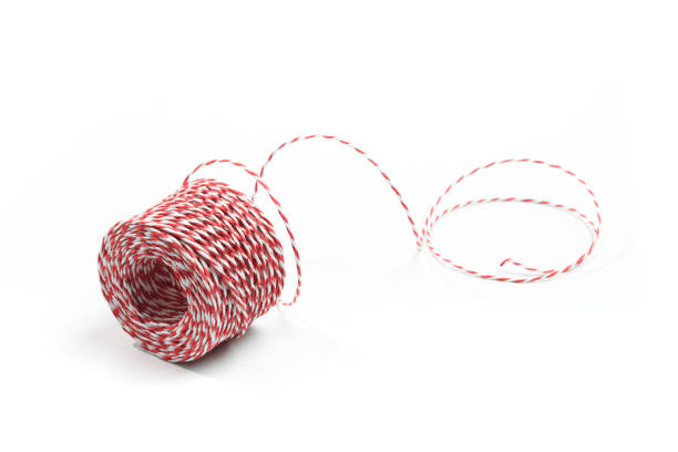 istock Red and white bakers twine rope spool isolated on white background. Packaging equipment or handicraft tool concept. 1192258829