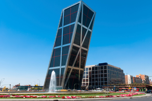 The Puerta de Europa towers (Gate of Europe or just Torres KIO) are twin office buildings in Madrid, Spain. Have a height of 114 m (374 ft) and 26 floors. Constructed from 1989 to 1996.