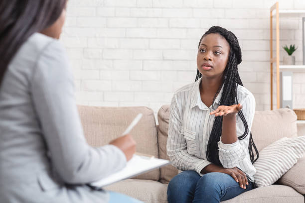istock Sad african american woman sharing her problems at counselor's office 1192259845