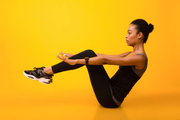 istock African American Woman Doing Abs Exercise With Leg Raise, Studio 1192260290