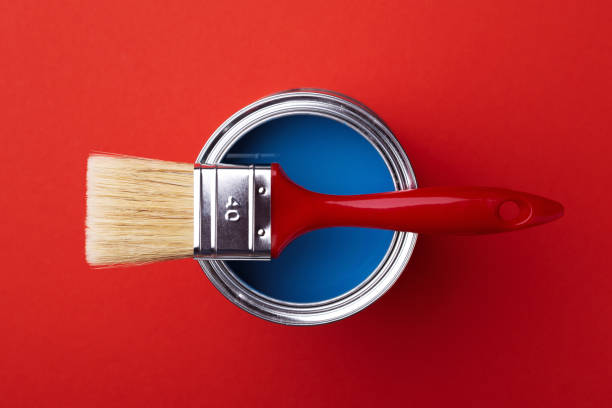 istock Can of blue paint on red. 1192260404