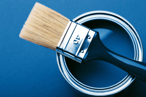 istock Can of blue paint on red. 1192260408