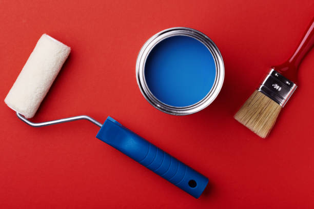 istock Can of blue paint on red. 1192260421
