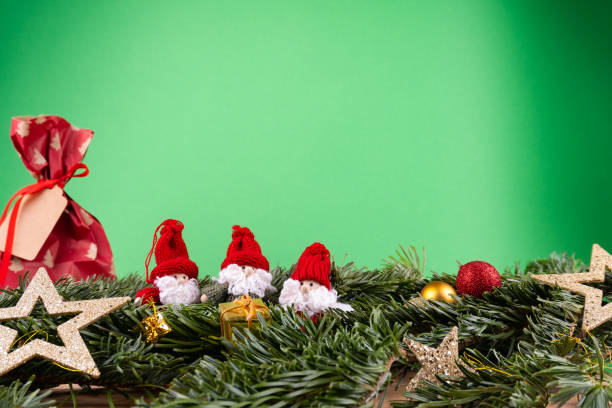 Christmas ornaments (dwarfs, present, stars, baubles) and fir twigs in front of a green background Christmas ornaments (dwarfs, present, stars, baubles) and fir twigs in front of a green background dwarf pine trees stock pictures, royalty-free photos & images