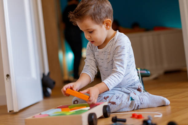 istock Concetrated boy arranging wooden blocks 1192261439