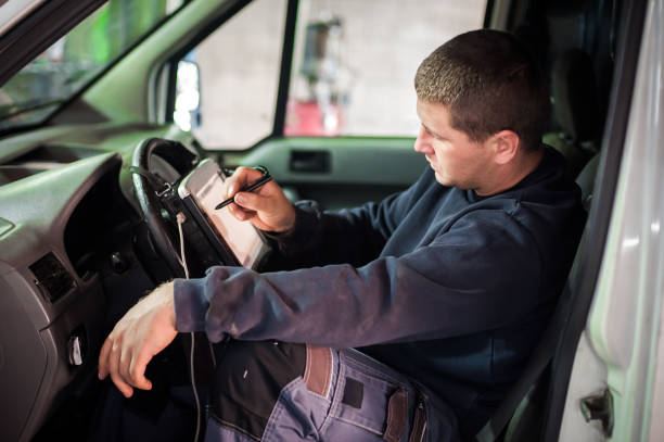 istock Automobile computer diagnosis. Car mechanic repairer looks for engine failure 1192262962
