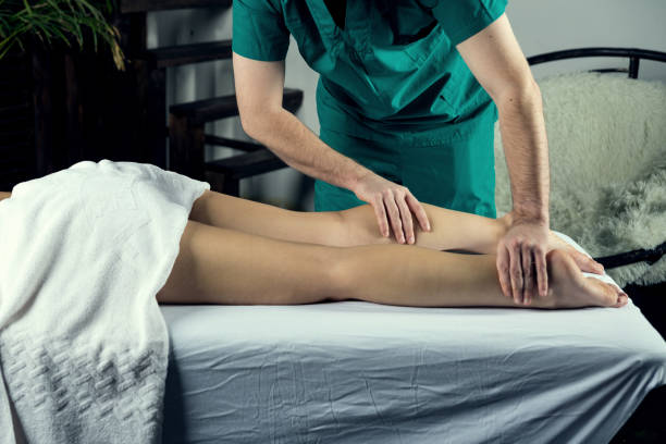 Lymphatic drainage massage of the hips. A male massage therapist gives a massage to a young woman Lymphatic drainage massage of the hips. A male massage therapist gives a massage to a young woman man touching womans buttock stock pictures, royalty-free photos & images