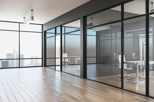 Grey office interior with glass, wooden floor, furniture, city view and daylight. 3D Rendering