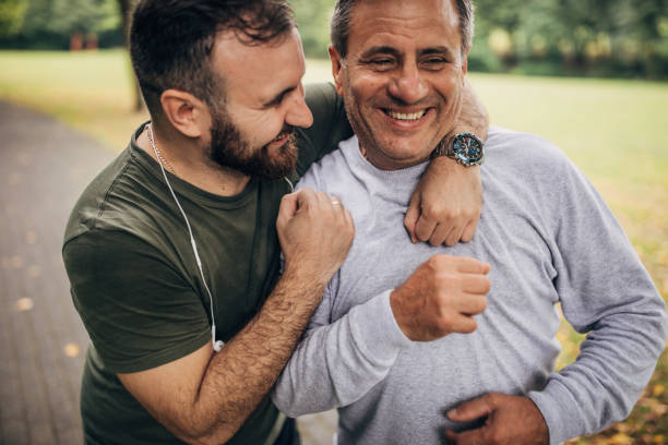 istock Man and son exercising in park 1192265719