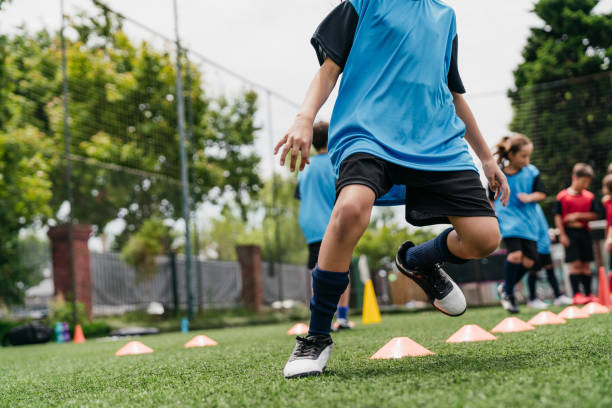 istock Determined girls and boys practicing soccer drills on field 1192266038