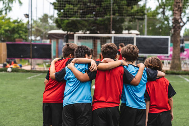 istock Boys standing arm around on soccer field 1192266052