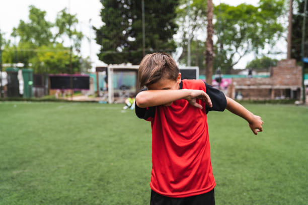 Soccer player boy doing the dab dance standing on a soccer field Soccer player boy doing the dab dance standing on a soccer field. He's celebrating. He's wearing red jersey. dab dance photos stock pictures, royalty-free photos & images