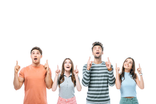 istock shocked friends pointing up isolated on white 1192266791