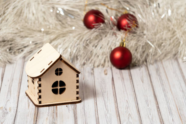 toy wooden house on a wooden table decorated with a garland and red christmas balls for new year or xmas - key ring fotos imagens e fotografias de stock