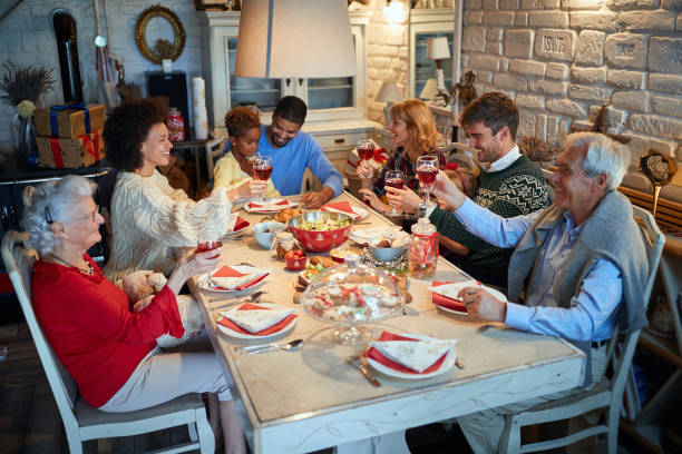 istock People having Christmas dinner at home with happy friends 1192269821