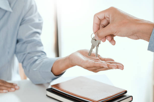 istock Midsection Of Real Estate Agent Giving Keys To Client 1192270064