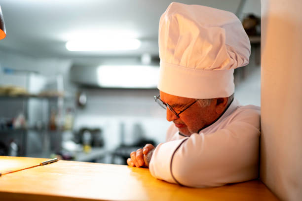 istock A tired / worried senior chef in the kitchen counter 1192270662
